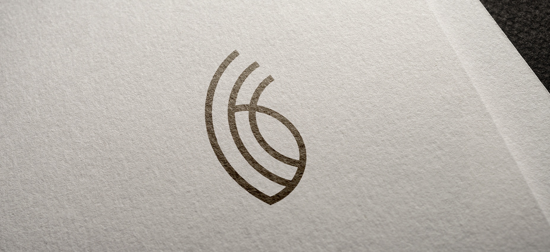 Prancheta 2 curved emblem logo on textured paper